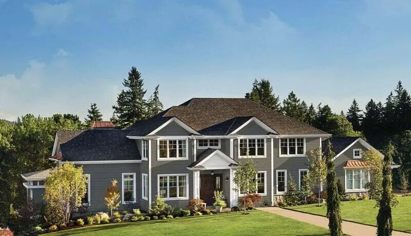 Two-story home with Alside Ascend composite cladding in sage green with white trim and covered front porch