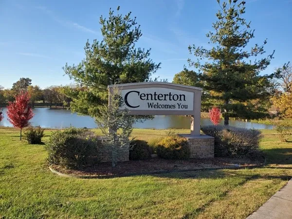 Centerton Welcomes You entrance sign with pond and fall foliage in Centerton, Arkansas